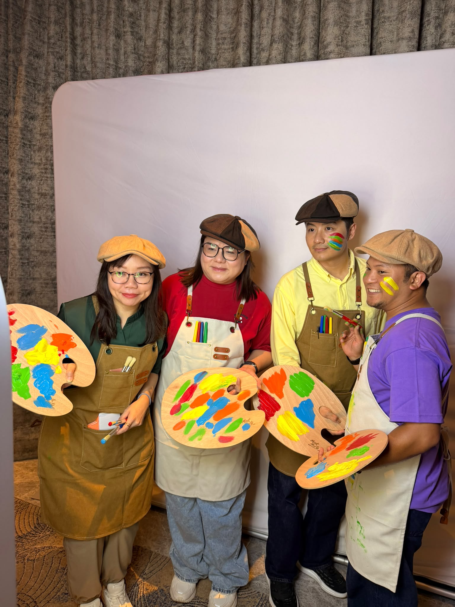 Team dressed as painters with palettes at a corporate photobooth