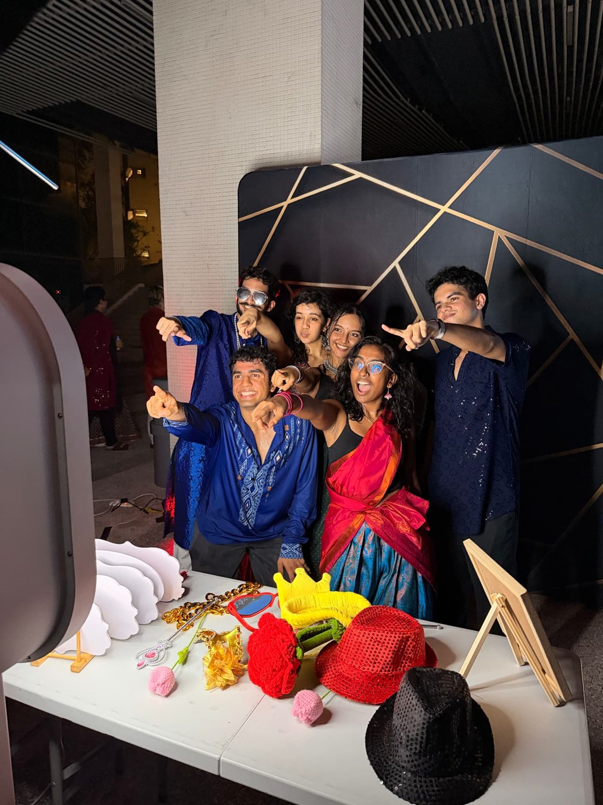 Colleagues taking a group photobooth picture during an event in Singapore