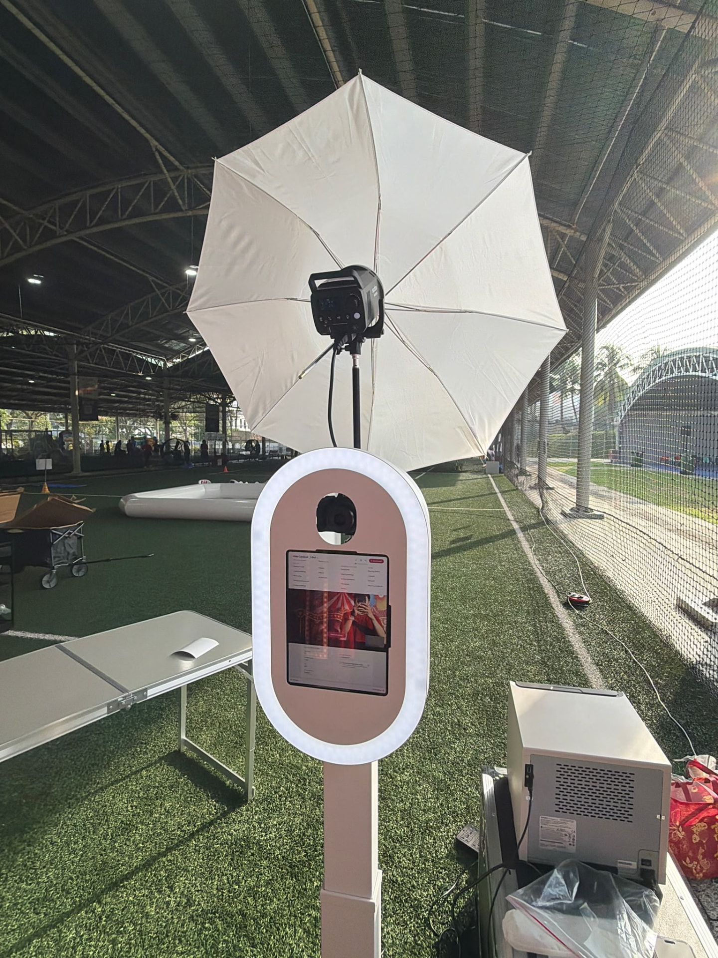 AI Booth SG photobooth kiosk and umbrella lighting set up at a real event