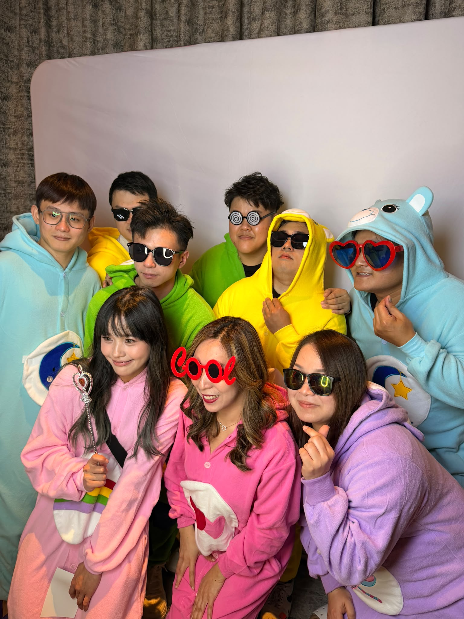 Colleagues in colourful onesies enjoying a real corporate D&D photobooth