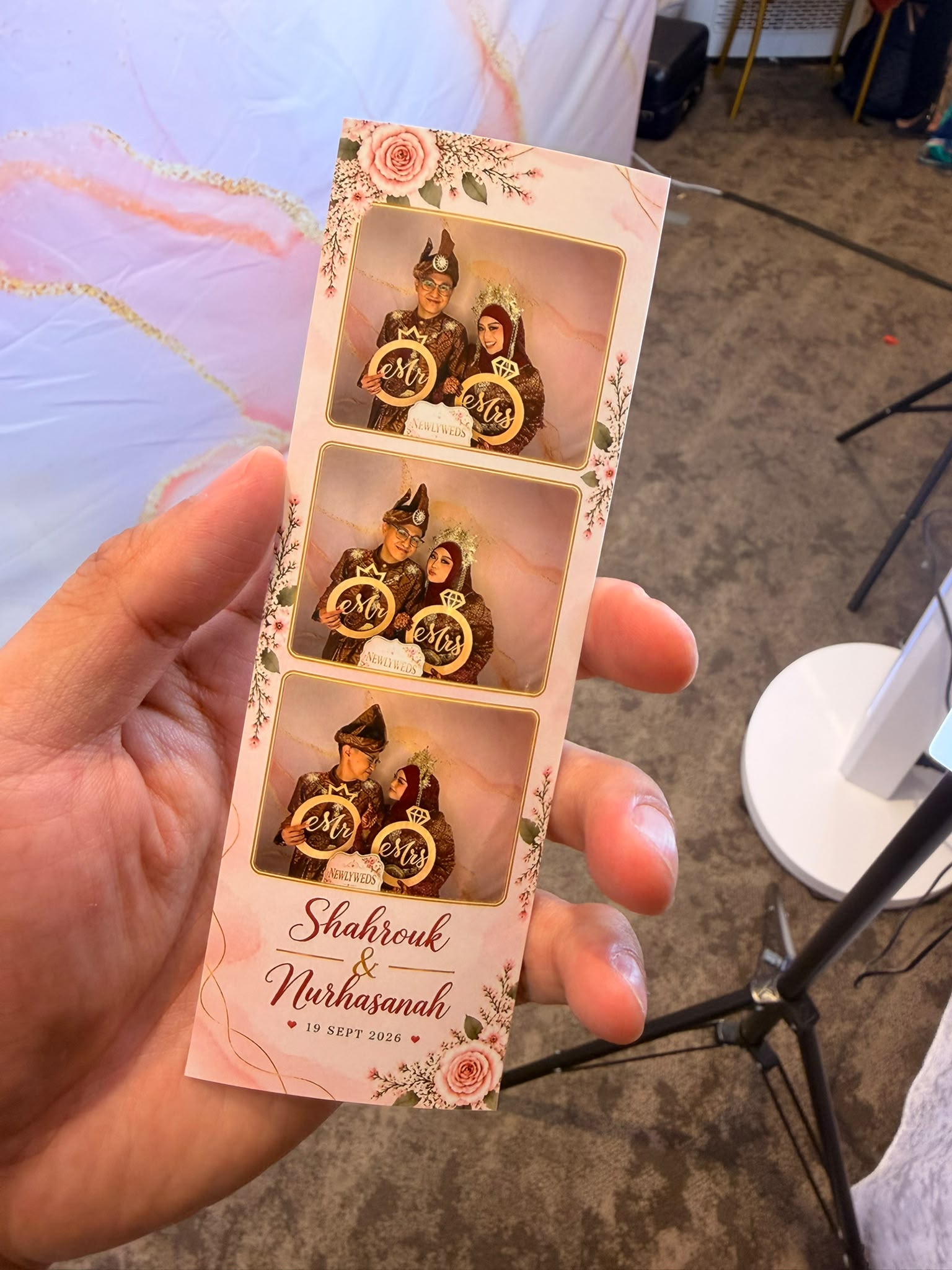 Guest holding a freshly printed wedding photo strip