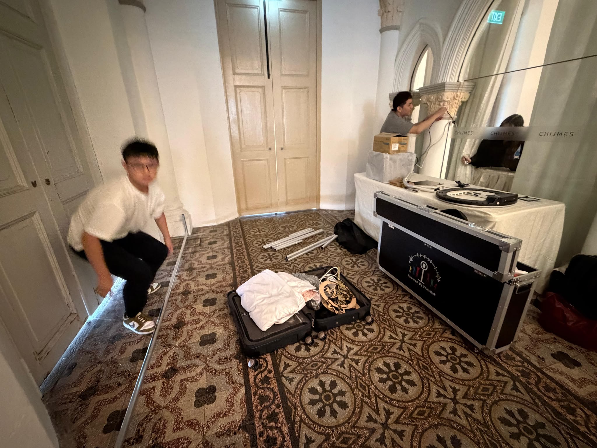 Operator preparing photobooth equipment and cases before guests arrive