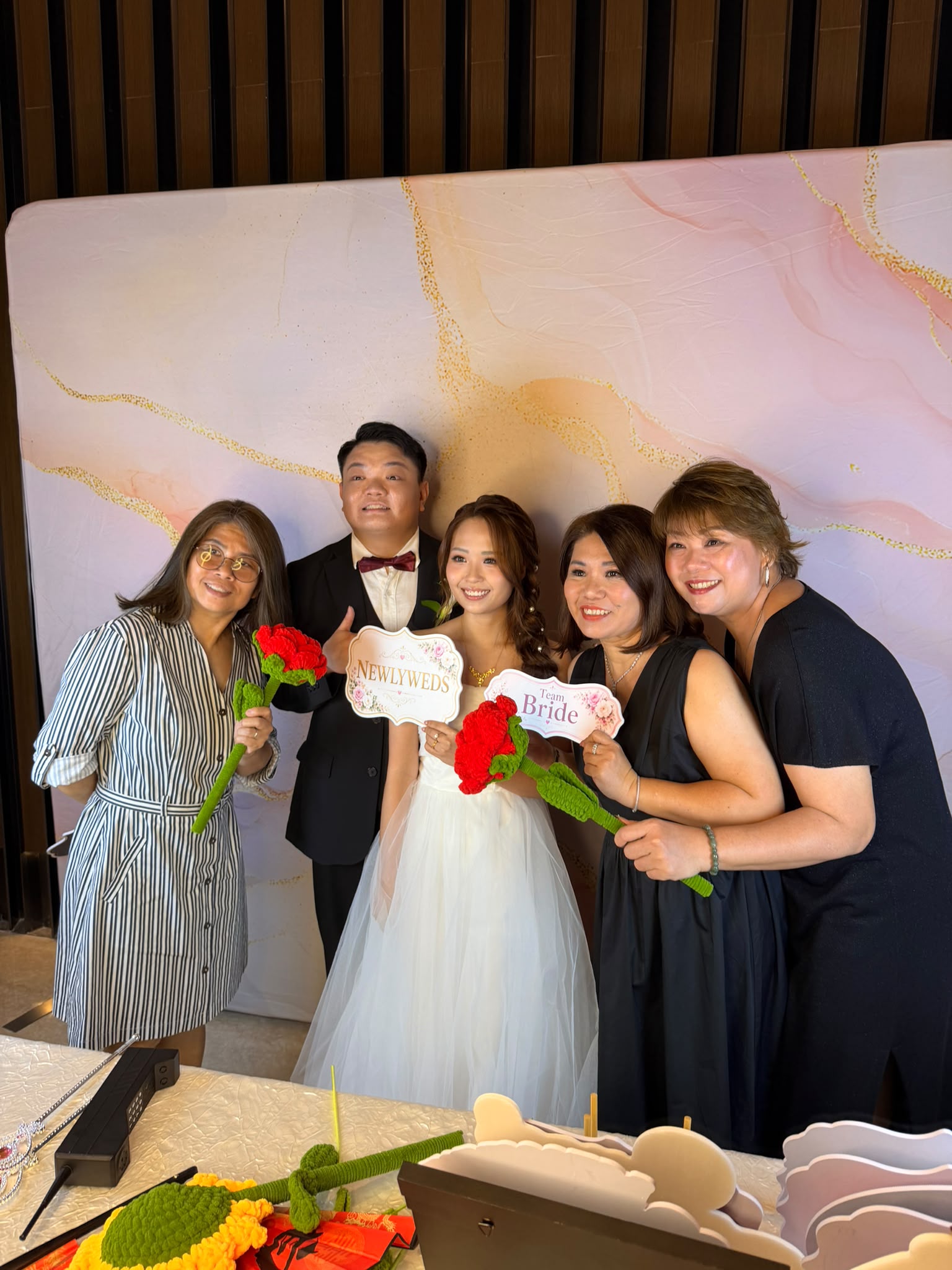 Newlyweds and family at a real wedding photobooth in Singapore